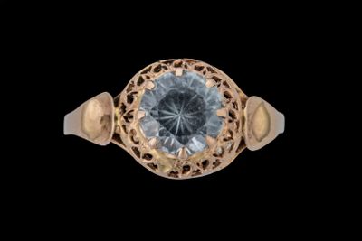 une image d'une bague en or avec une pierre en topaze bleue
