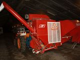 a large red machine that is parked inside of a building