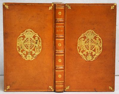 an old book with a golden design on the front and back