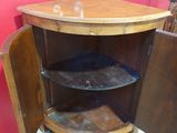 a small wooden cabinet with a glass shelf in it