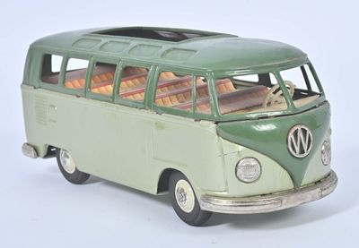 a green and white toy bus that is on a white surface
