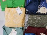 a lot of clothes that are sitting on a table