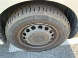 a close up of a tire on a white car