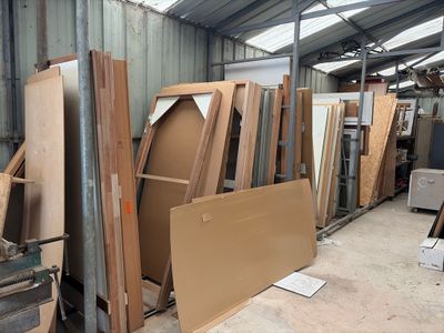 several pieces of wood are stacked up in a warehouse