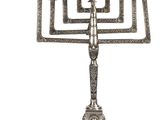 a silver plated menorah with five candles on a stand