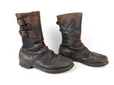 pair of brown leather boots with buckles and buckles on them
