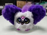 a purple and white stuffed animal with big eyes