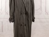 an image of a coat on a mannequin stand in a room