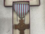 two medals on display in a case on a table