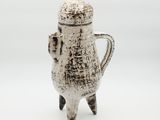 a white coffee pot that is sitting on a table