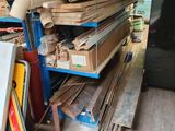 a pile of wood on a shelf in a garage