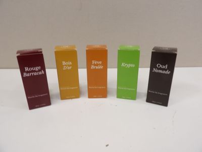 four bottles of perfume sitting on top of a white table