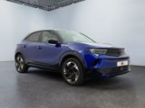 a blue toyota c - hr suv parked in a large room