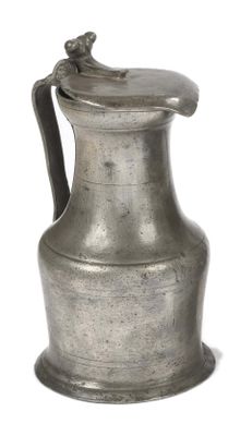 an old silver pitcher with a handle on a white background