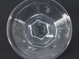 a clear glass bowl on a black surface