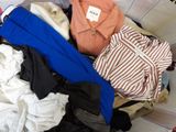 a pile of clothes in a basket on the floor