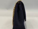 a close up of a black purse with a gold chain around it