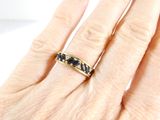 a woman ' s hand with a gold ring on it