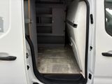 a white van with the door open and a shelf in the back of the van