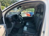 the interior of a white truck with black seats and a door open