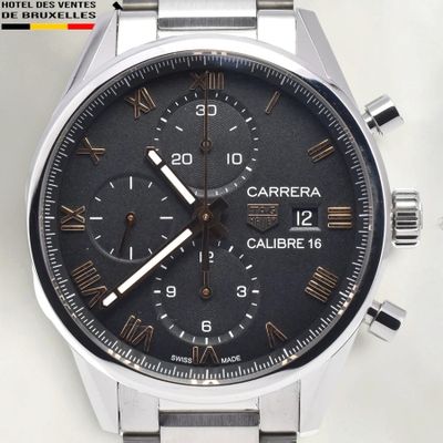 a close up of a watch on a white surface