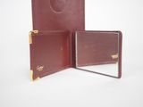 burgundy leather wallet with mirror on white background