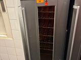two stainless steel ovens in a kitchen with tile flooring