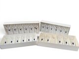 four wine glasses in a white box on a white surface