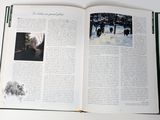 an open book with pictures of animals in the snow