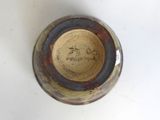 a close up of a vase with writing on it