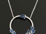 a white gold necklace with blue sapphires and diamonds