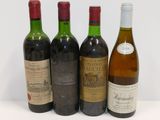 three bottles of wine are lined up on a white surface