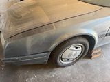 a car that is sitting in a garage with it ' s hood up