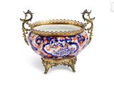 a large bowl with a handle on a stand