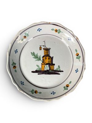 une assiette sur laquelle est représenté un phare