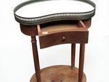 a small wooden table with a mirror on top of it