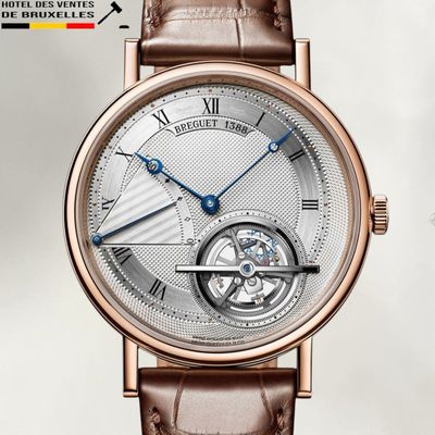 a close up of a wrist watch with a brown leather strap
