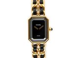 a close up of a black and gold watch on a white background