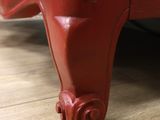 a close up view of a red piece of furniture on the floor