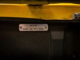 a sign on the side of a yellow bus