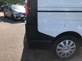 a white van parked in a parking lot next to other cars