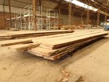 several pieces of wood are stacked up in a large warehouse
