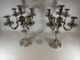 pair of silver plated candlesticks on a white table