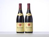 two bottles of red wine sitting next to each other on a table