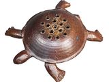 a brown turtle shaped incense holder on a white background