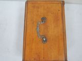 a small wooden box with a key on it