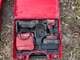 a red tool box with tools in it on the ground