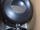 a box that has a black toilet inside of it
