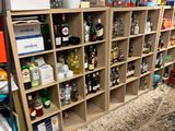 a room with a lot of bottles and boxes on the shelves