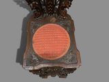 an old clock with a red light in the middle of it
